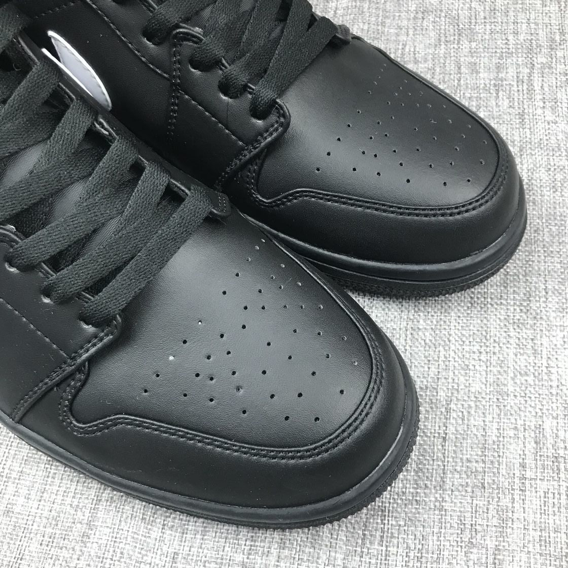Close-up of the perforated black toe boxes and black lace-up sections on the pair.