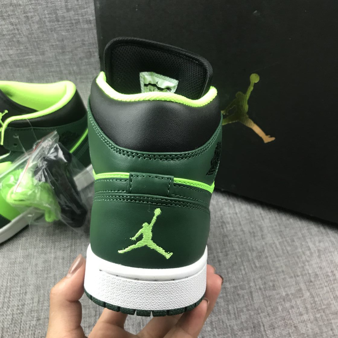 Close rear view showing the dark green heel, fluorescent green trim, and white midsole.