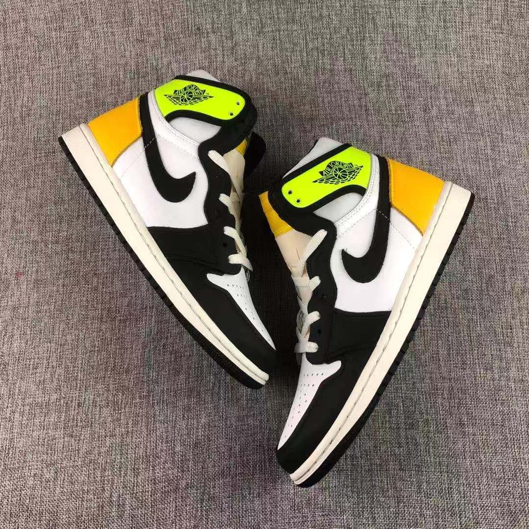 Pair of Volt Gold, black and white high-top sneakers arranged on a gray surface.