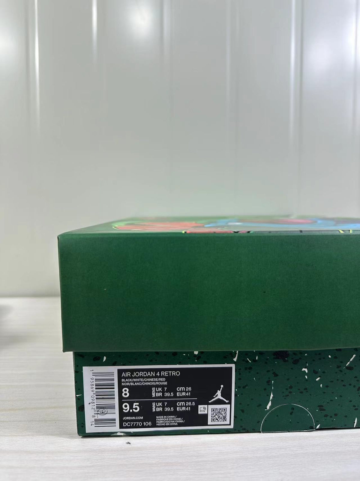 Green shoebox with a product label showing Air Jordan 4 Retro, sizes 8 and 9.5, and style code DC7770-106.