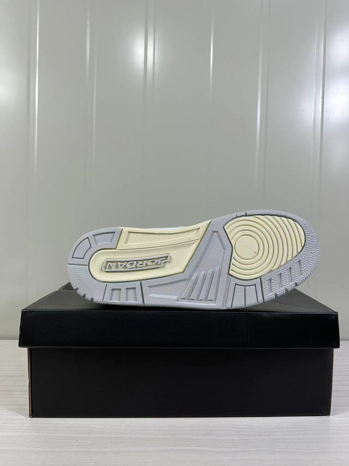 Bottom view showing the patterned rubber outsole with circular forefoot traction and Jordan branding.