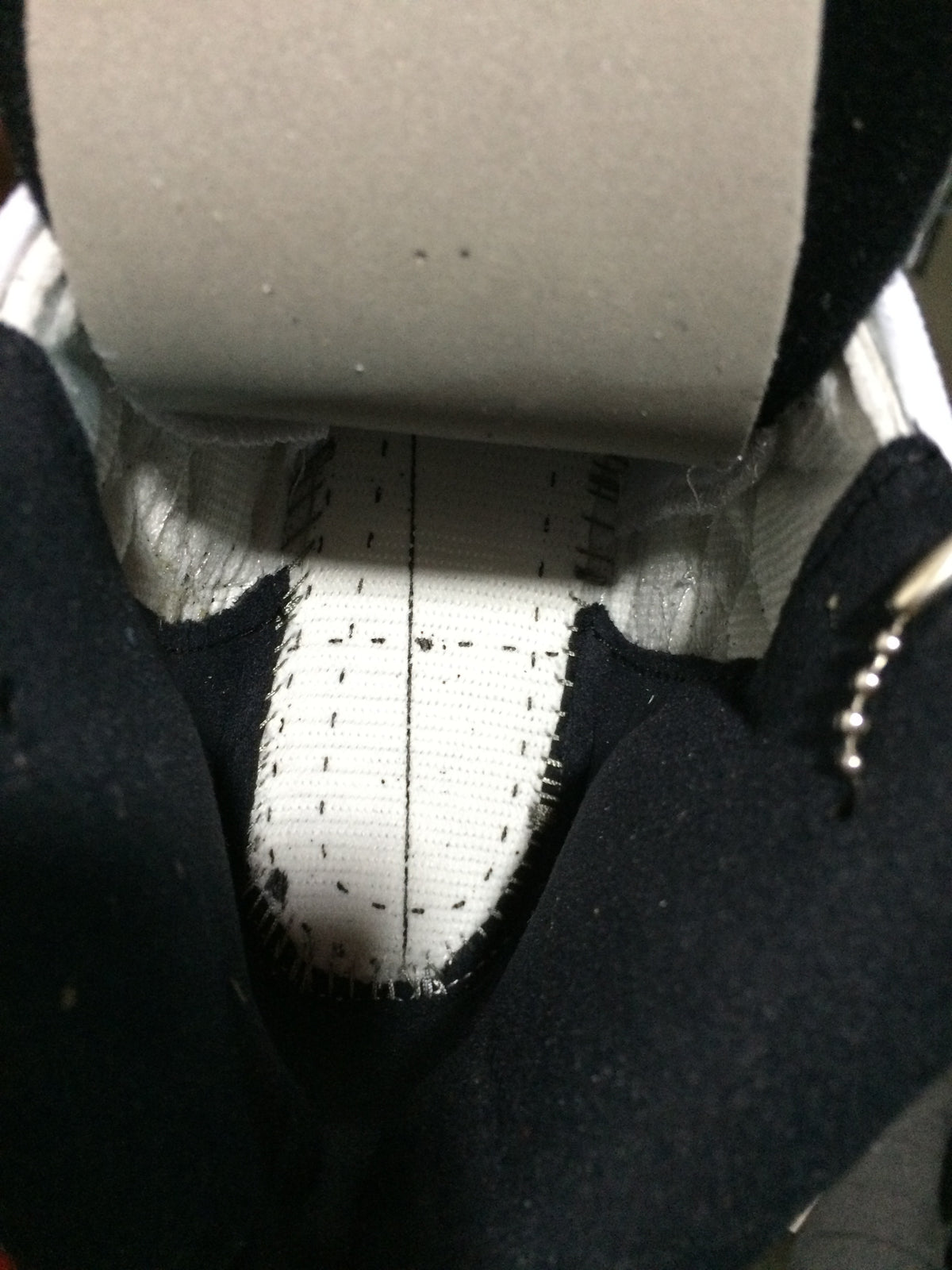 Close-up photograph of the inside of the sneaker showing interior stitching and lining.