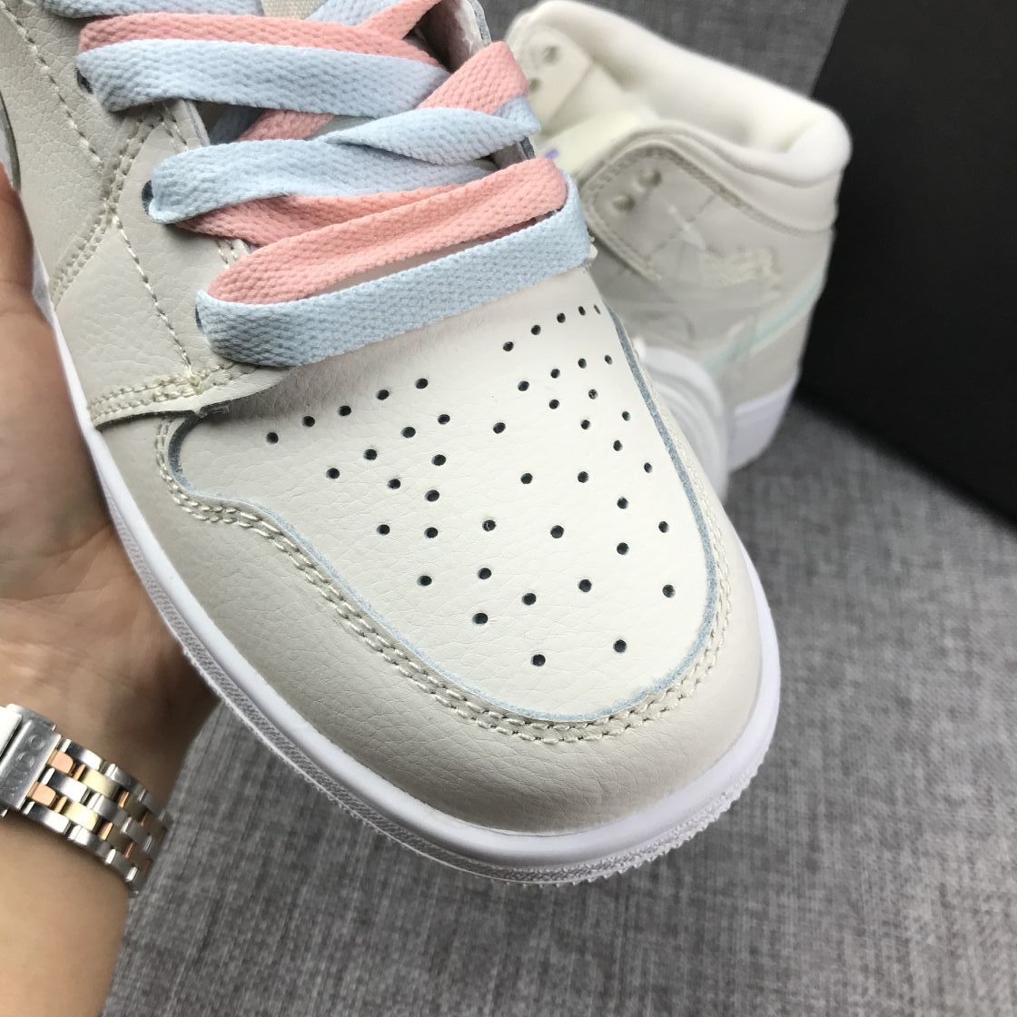 Close-up of the perforated off-white toe box and layered blue-and-pink laces.