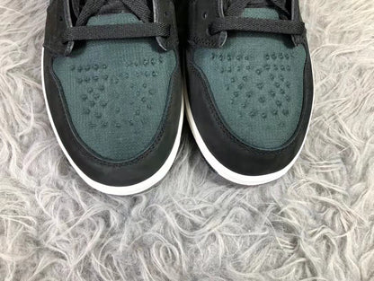 Close-up of the dark green textured toe boxes framed by black overlays and white midsoles.