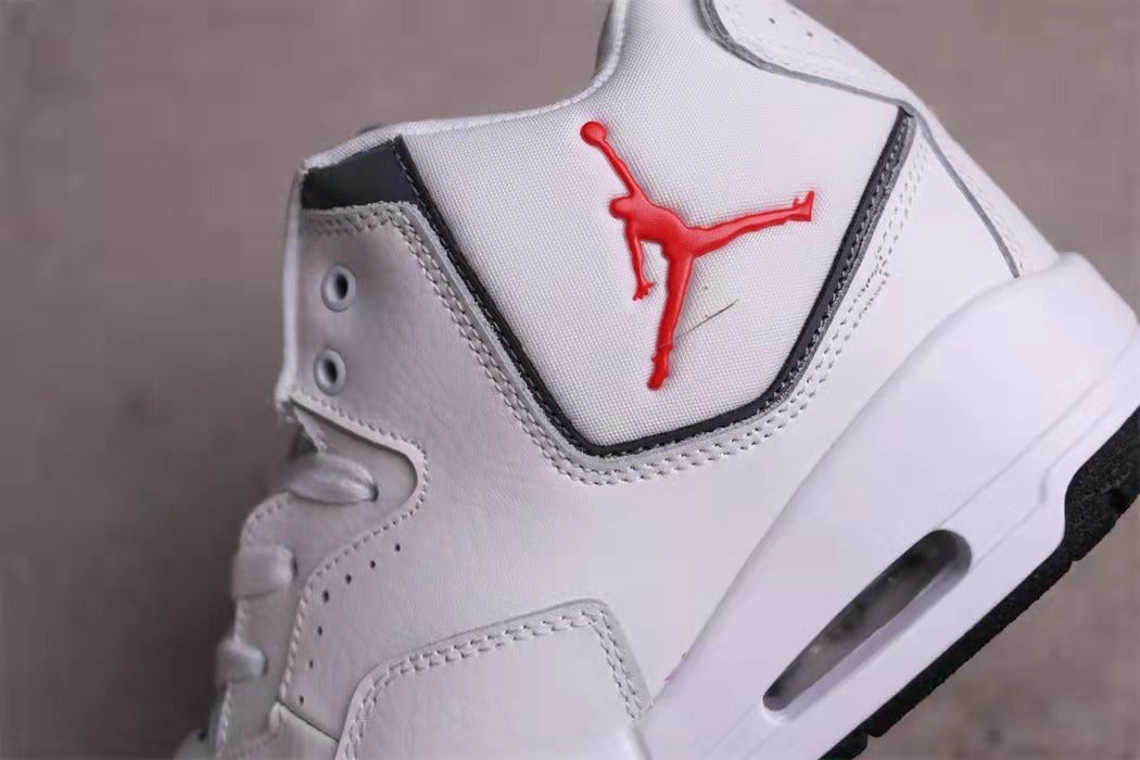 Close-up of the white sneaker side panel with black edging, perforations, and red Jumpman branding