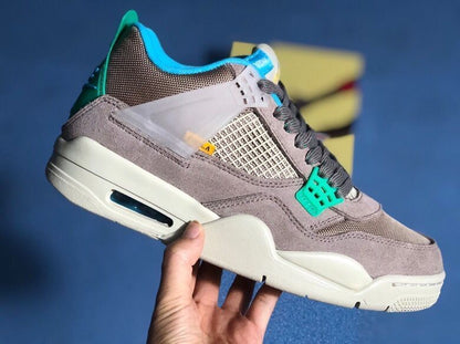 Side view of grey Jordan Air Jordan 4 Retro SP sneakers with teal accents and a light midsole.