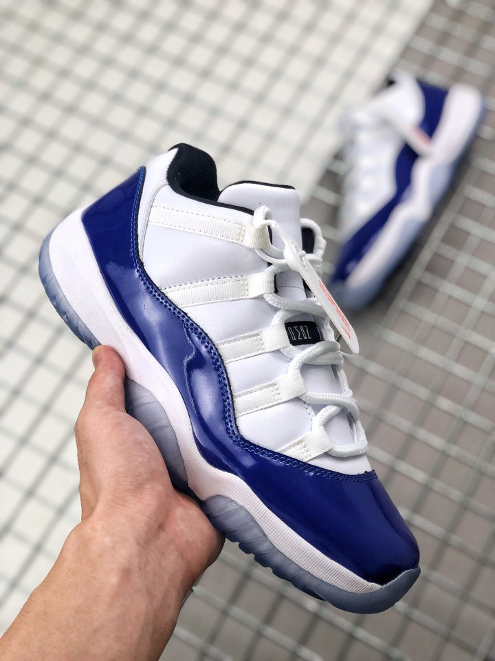 Angled top-side view showing the lacing system, tongue, blue toe overlay, and heel.