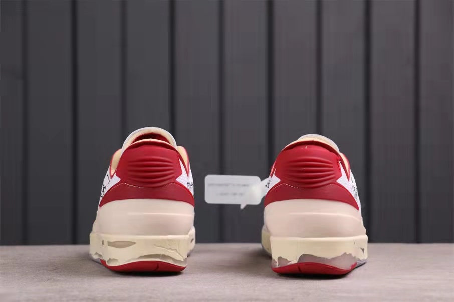 Rear view showing red heel details, cream midsoles, and gray-red outsole edges.