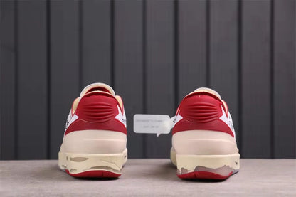 Rear view showing red heel details, cream midsoles, and gray-red outsole edges.