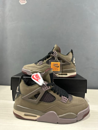 Three-quarter view of the sneakers with a clear branded hangtag and black shoebox.