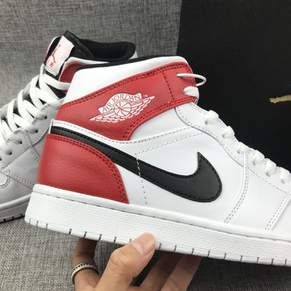 Close-up side view of the red ankle panel, winged emblem, and black side logo.
