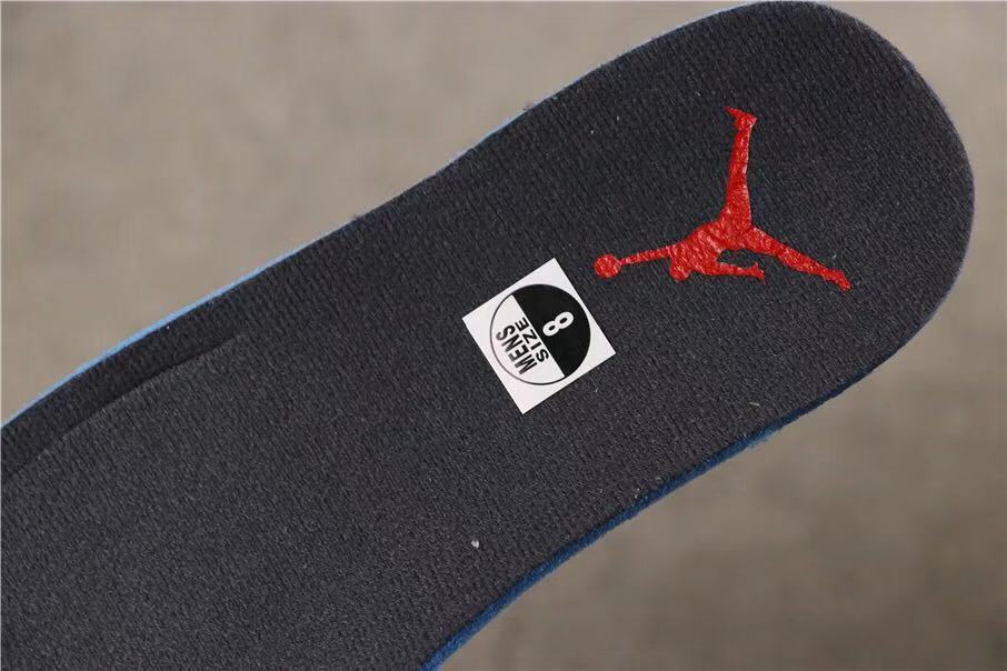 View of the dark insole with a red Jumpman logo and size sticker marked 8.