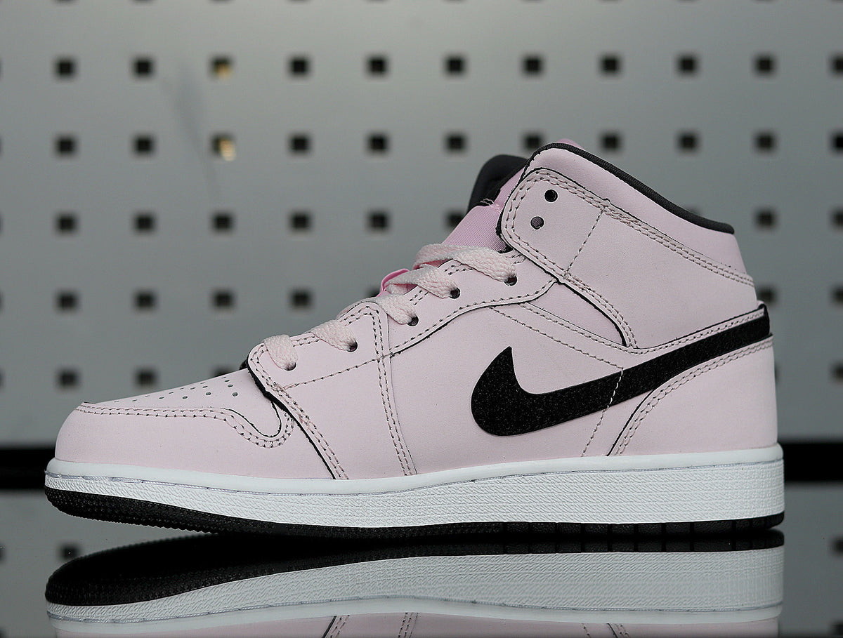 Pink high-top sneaker with a black Nike Swoosh, pink laces, and a white-and-black sole shown in side profile.