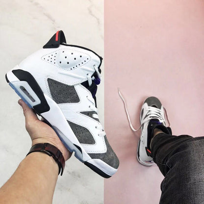 Side profile showing the perforated white upper, grey panels, black midsole accents, red heel detail, and translucent outsole.