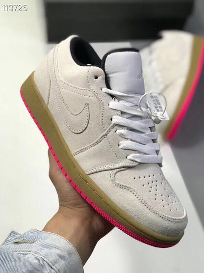 Three-quarter view of a gray low-top sneaker with white laces, side Swoosh detailing, and a pink outsole.