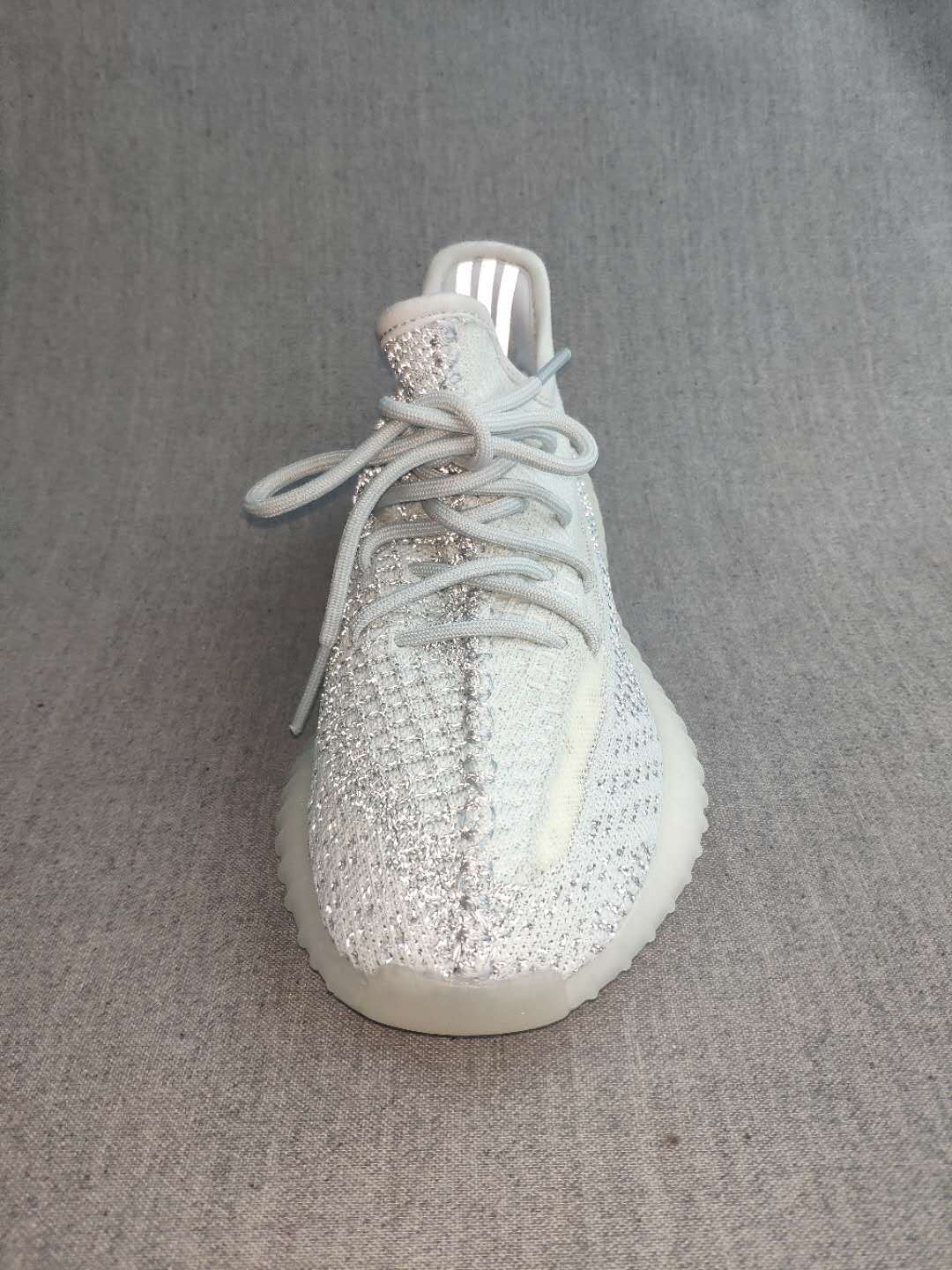 Front-top view showing the laces, knit-look upper, reflective-looking tongue area, and rounded toe.