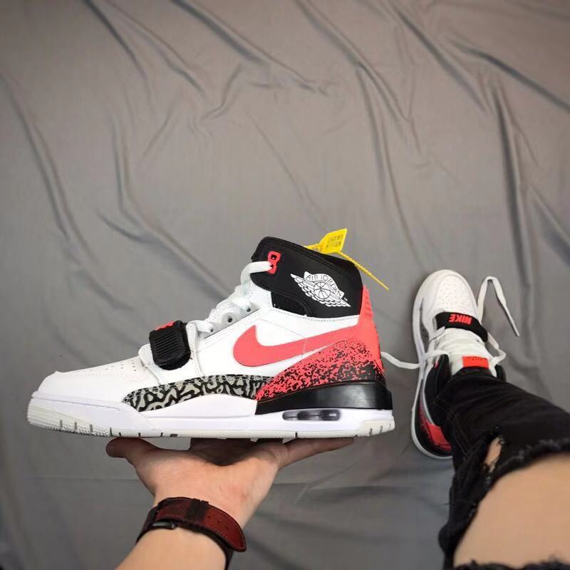 Side view of a white, black, and red high-top sneaker with a forefoot strap, elephant-print panel, and visible midsole window.