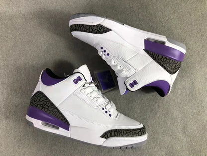 Overhead view of the pair showing the white uppers, purple accents, dark patterned overlays, and midsoles.
