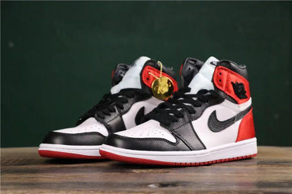 Angled front view of the pair displaying the black, white, and red color blocking.