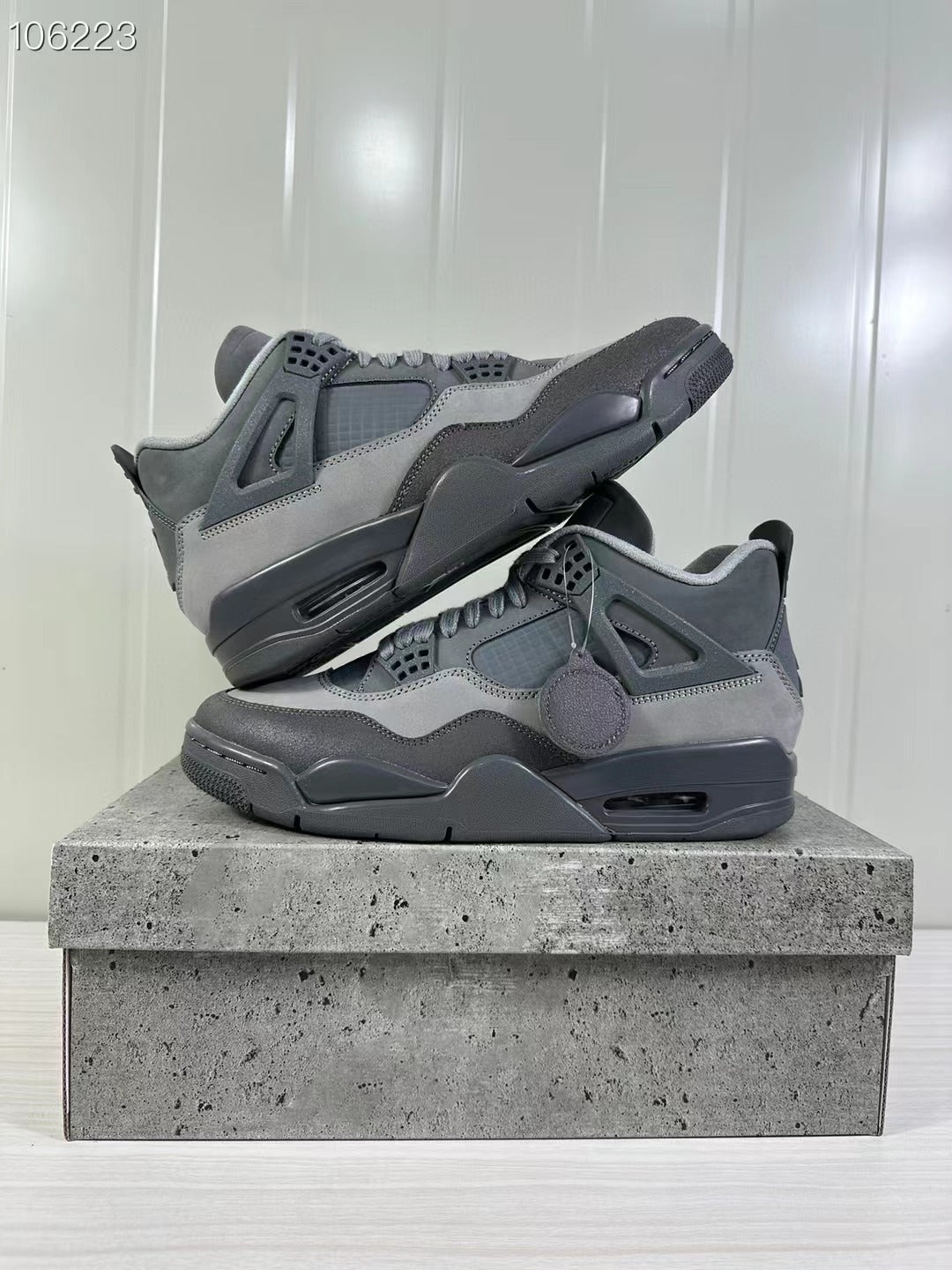 Angled product view showing the grey upper, dark midsole, and visible outsole edge.