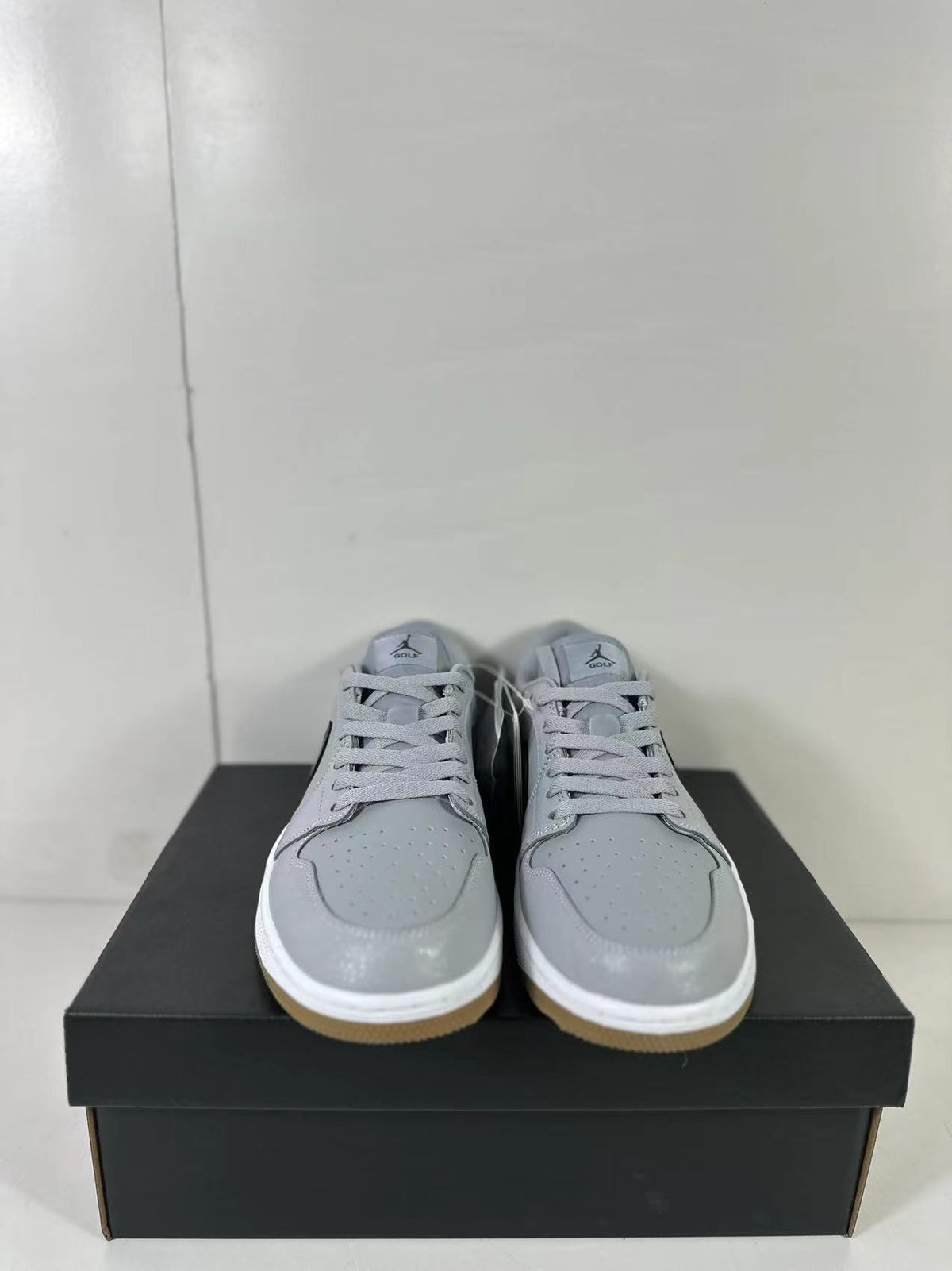 Front view showing the perforated toe boxes, grey laces, and gum-colored outsole edges.