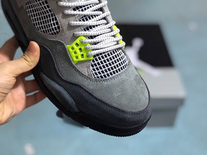 Close-up of the grey toe box, white mesh, laces, and bright green lace hardware.