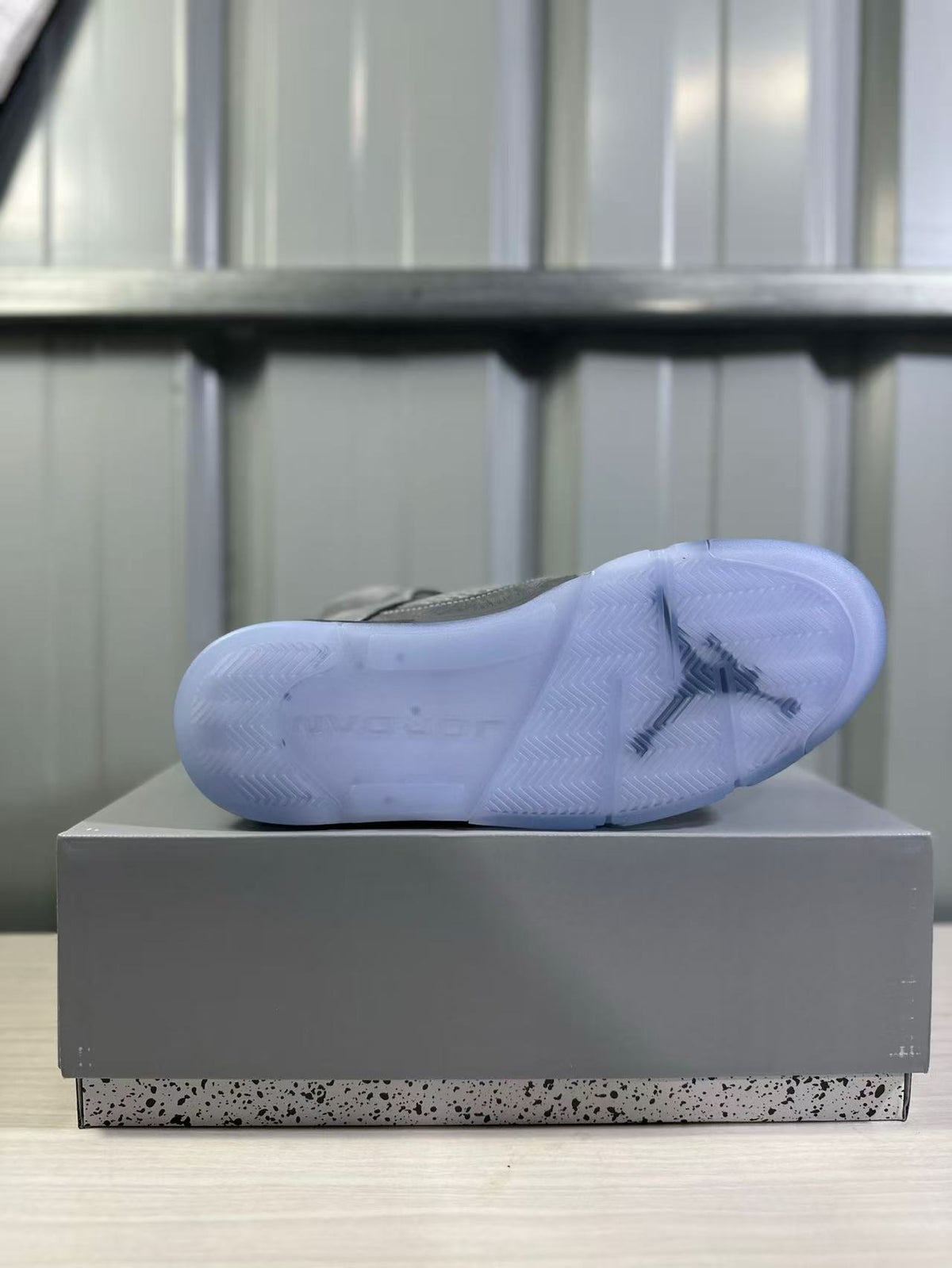 Bottom view showing the translucent blue outsole and its tread pattern.