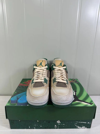 Front view of the pair showing cream laces, green lace supports, mesh panels and tan tongue labels.