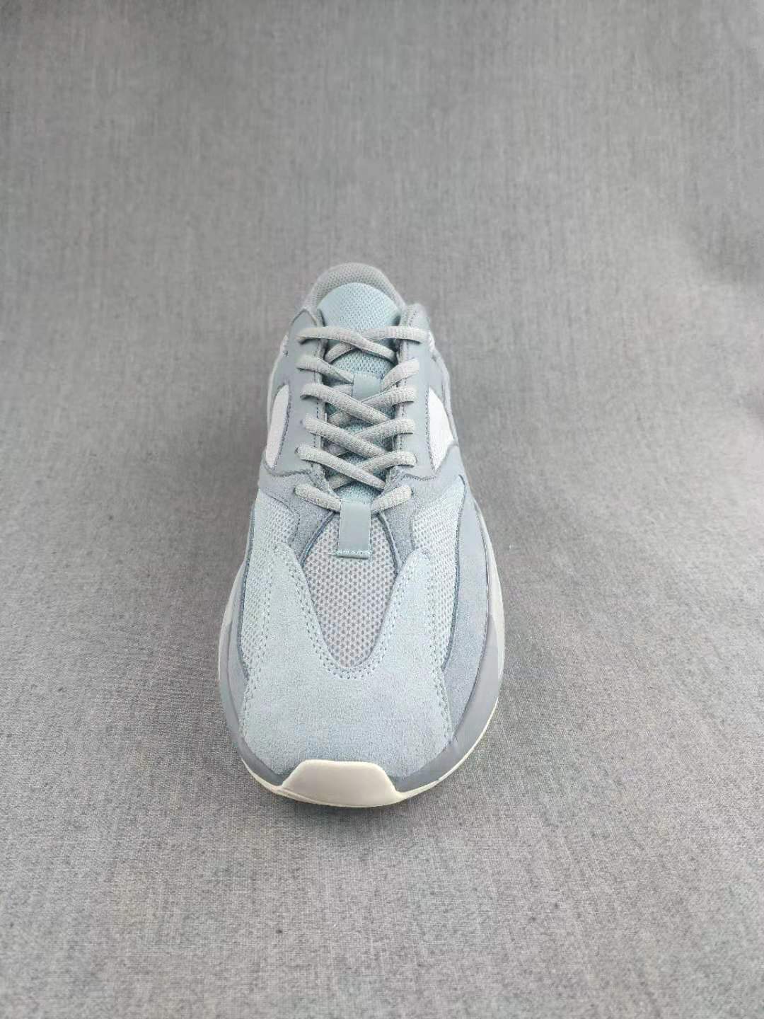 Top-down view showing the lace-up construction, mesh tongue, layered toe panels, and rounded toe shape.