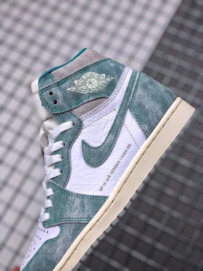 Close-up of the sneaker side showing the winged Jordan collar logo, teal-green overlays, white panels, and printed side detail.