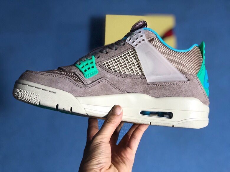 Lateral side view highlighting the grey upper, mesh panels, translucent side support, teal collar, and light midsole.