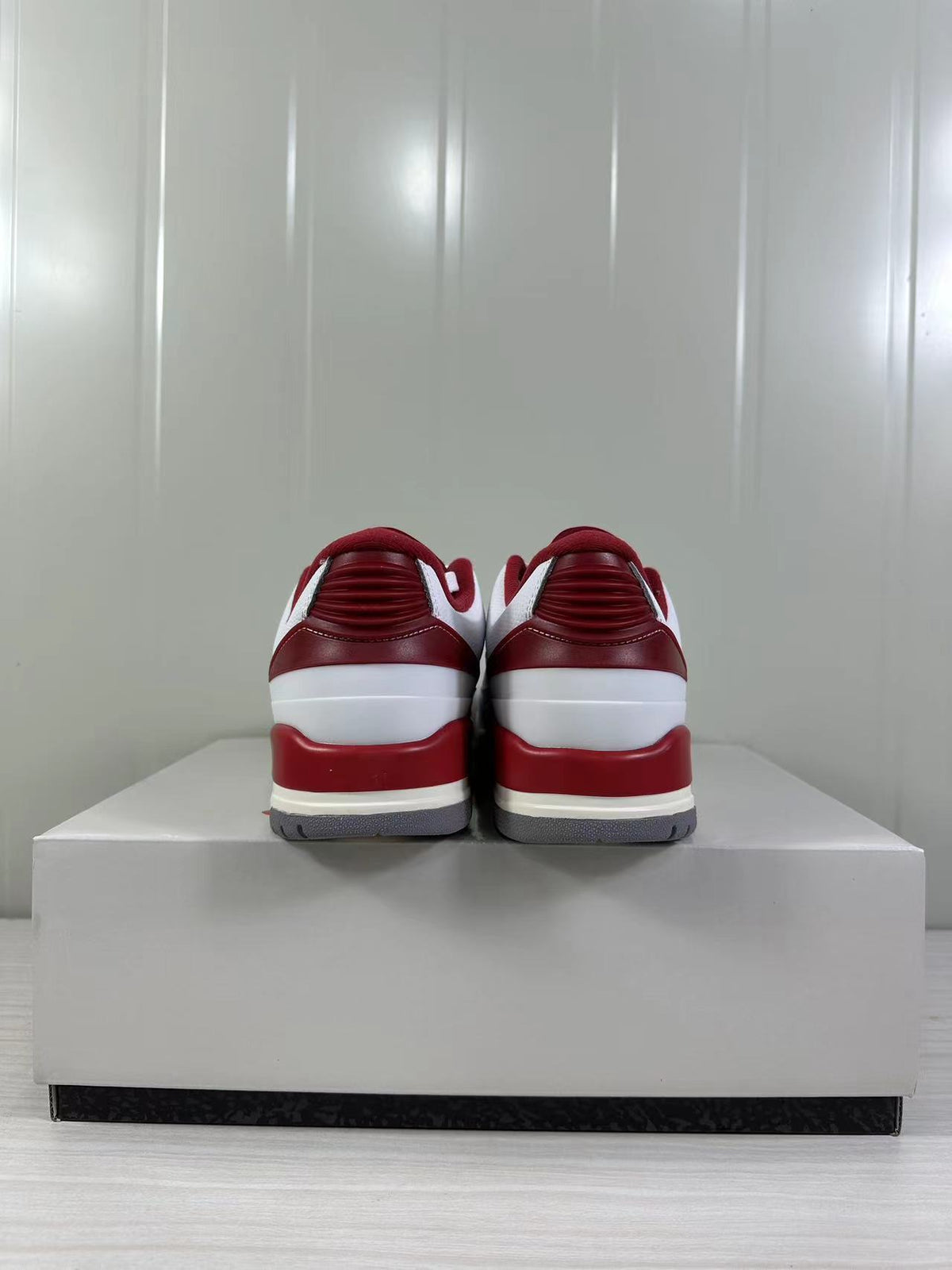Rear view highlighting the red padded collars, heel panels, and layered midsole.