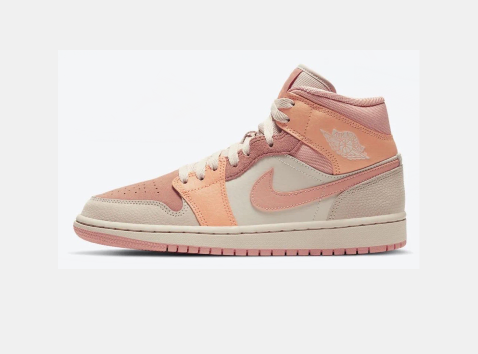 Side view of apricot orange, pink, and light beige Jordan high-top sneakers with a lace-up front, padded collar, side Swoosh, and textured rubber outsole.
