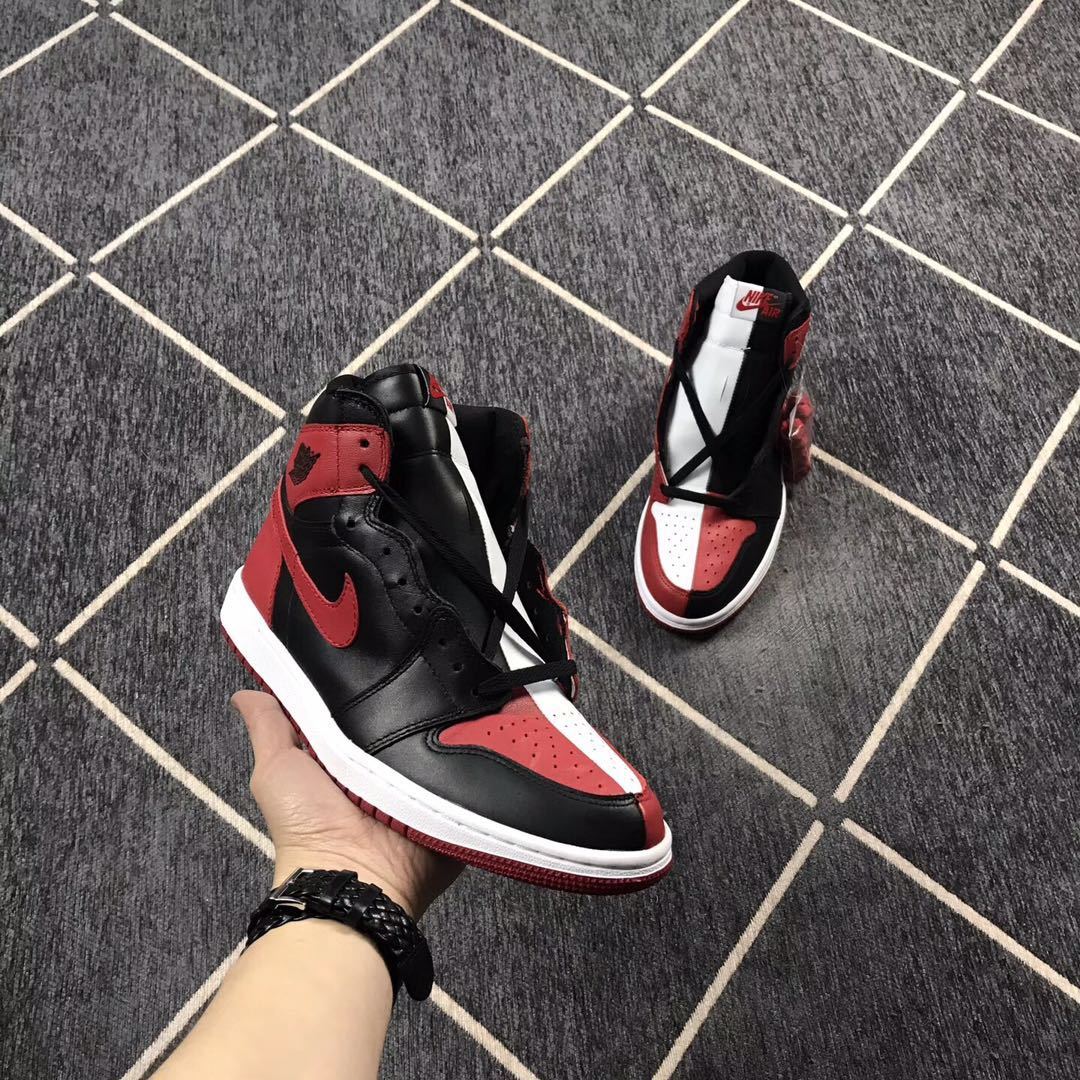 Pair of black, red, and white high-top sneakers shown from an angled top view.