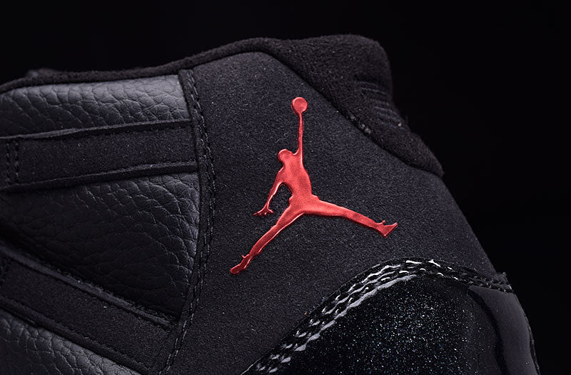 Close-up of the black padded tongue and red Jordan silhouette branding on the sneaker.