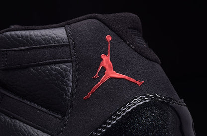 Close-up of the black padded tongue and red Jordan silhouette branding on the sneaker.