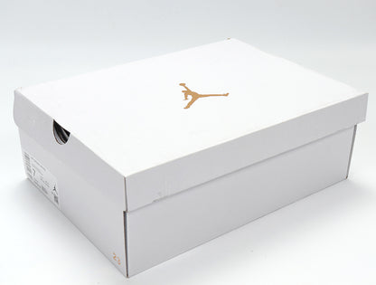 White Jordan shoebox with a gold Jumpman logo.