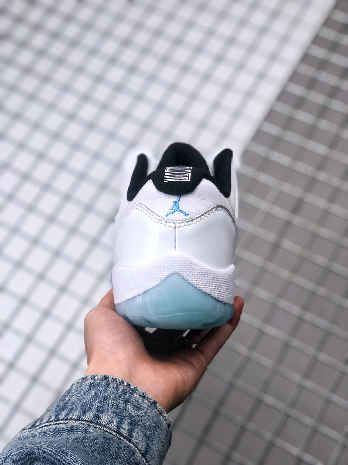 Rear view showing the black collar, blue heel logo, and translucent blue heel section.