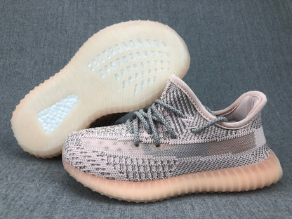 Three-quarter view of the pair with one shoe lifted to show the translucent outsole pattern.