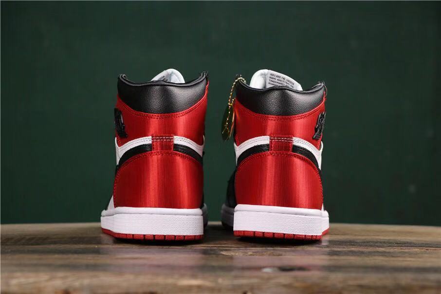 Rear view showing red heel panels, black collars, white midsoles, and red outsoles.