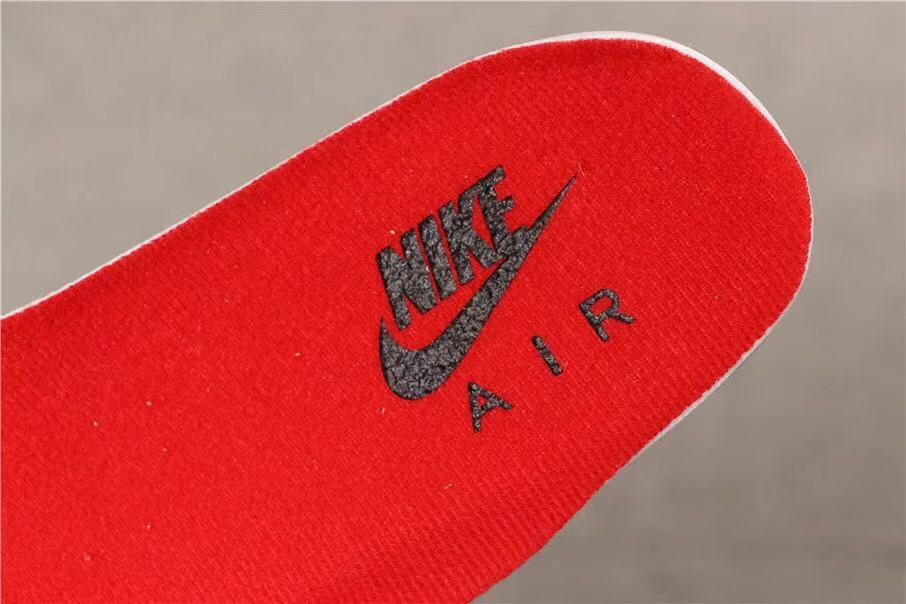 Close-up of a red insole with Nike Air branding.