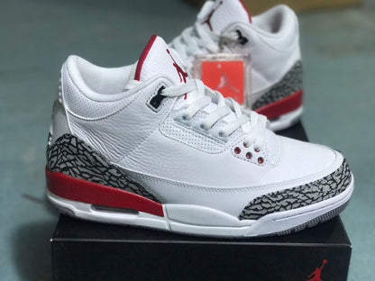 Side view of a white Jordan 3 Retro sneaker with elephant-print overlays and red heel detail