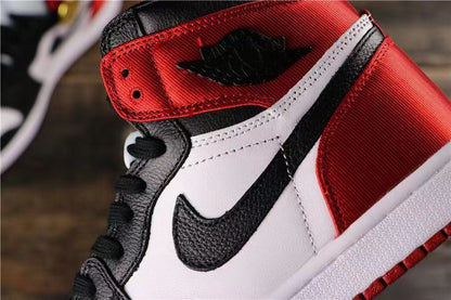 Close-up side view highlighting the black Swoosh, white panel, red collar, and stitching.