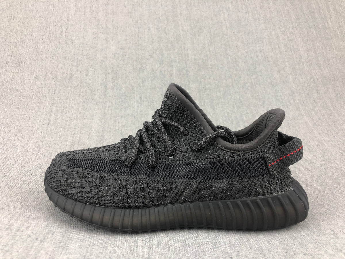 Side profile of the black sneaker with textured upper and sculpted ribbed sole.