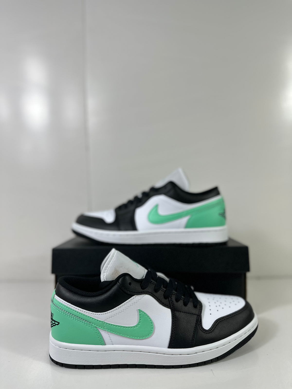Two-view product display showing the low-top sneaker from the side and front.