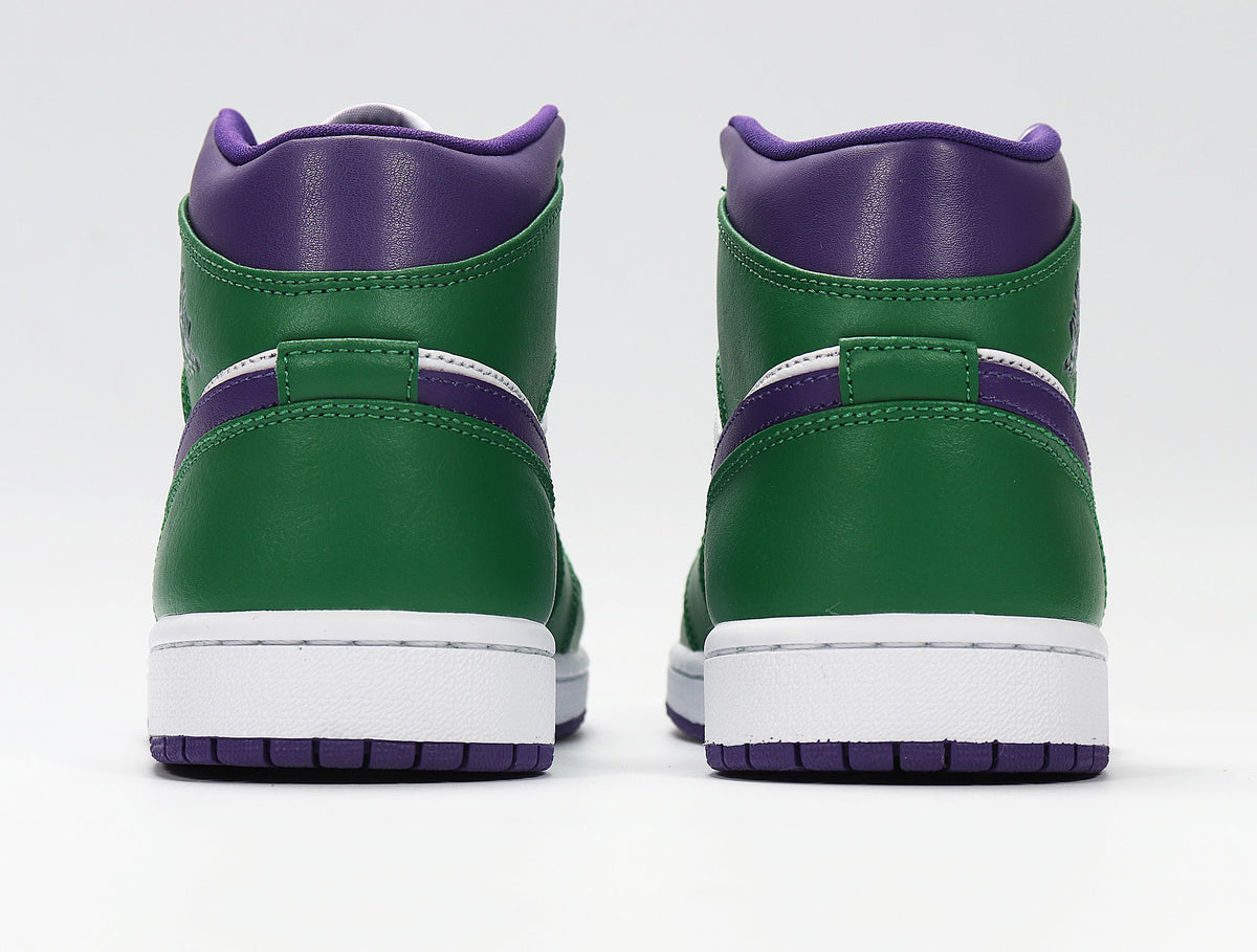 Rear view of green and purple high-top sneakers with white midsoles and purple outsoles.
