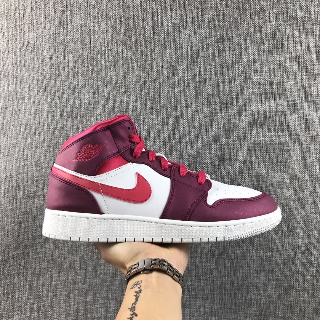 Side profile of a burgundy, white, and bright pink high-top sneaker.