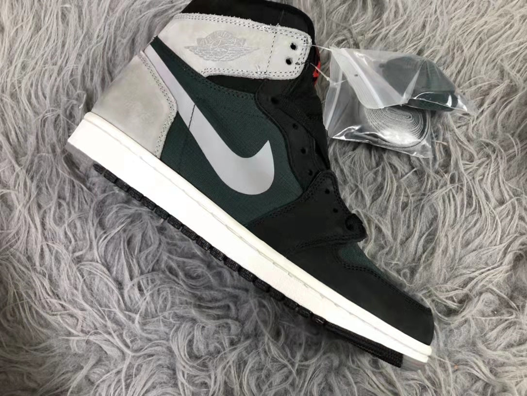 Side profile of a black and dark green high-top sneaker with a grey Swoosh-style side detail and white midsole.