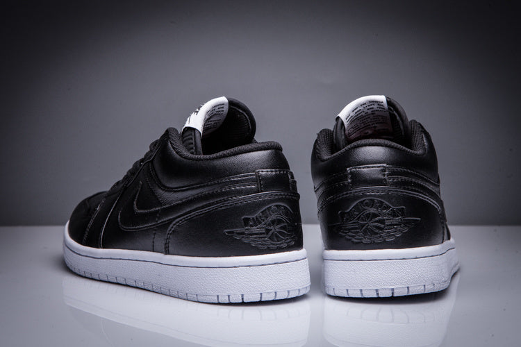 Rear view of the pair showing the embossed winged basketball heel emblems and white soles.