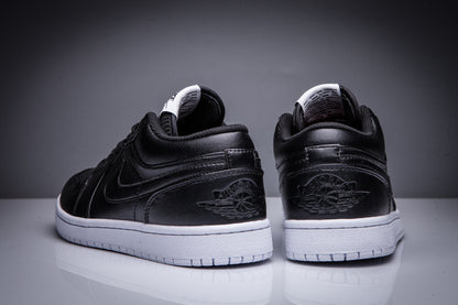 Rear view of the pair showing the embossed winged basketball heel emblems and white soles.